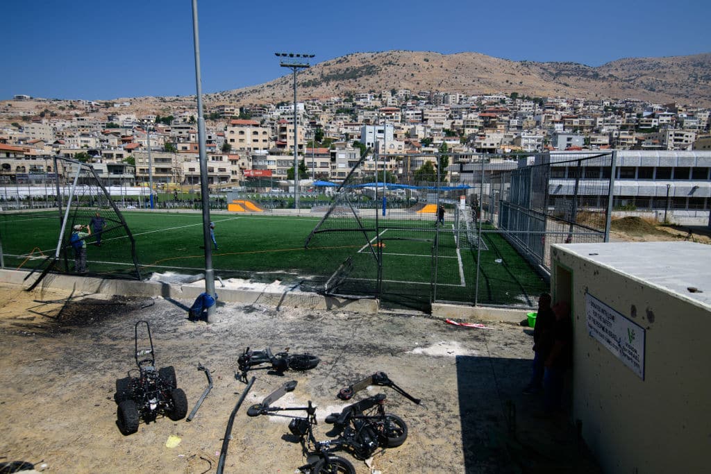 The rocket impact point at the football field. Israeli Druze mourners gathered for the funeral of 12 children and teens killed in a Hezbollah rocket strike at a soccer field in Majdal Shams, Golan Heights.