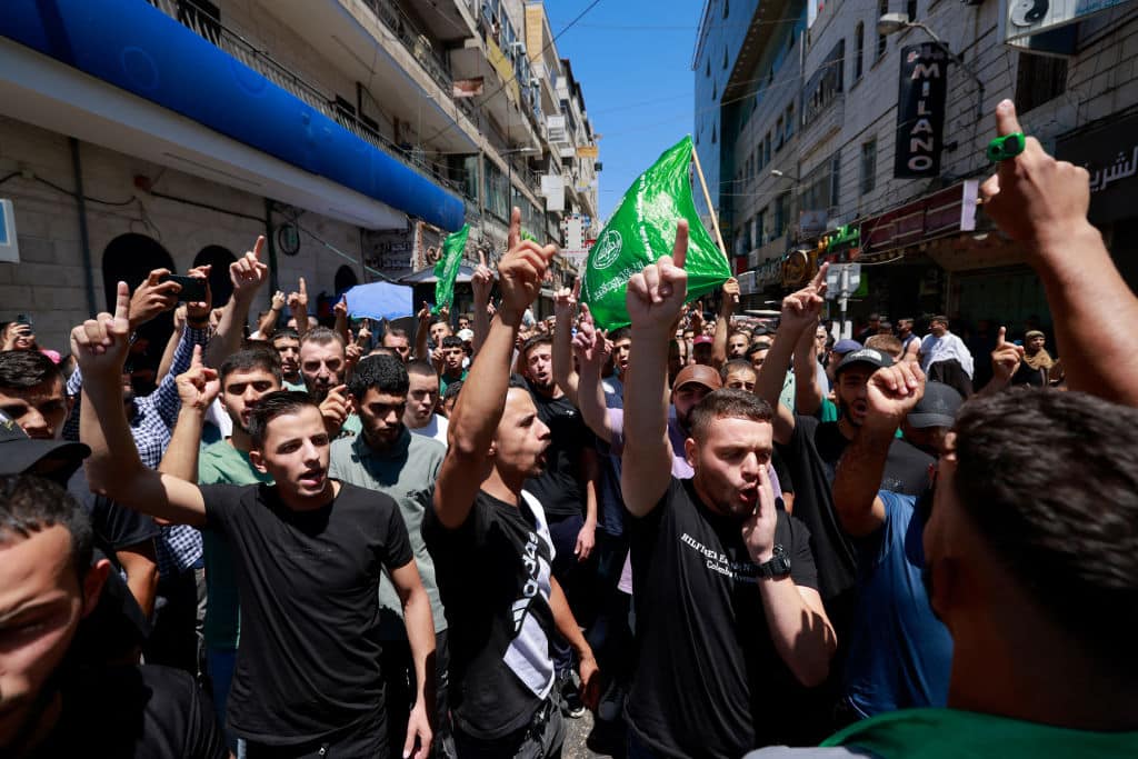 Palestinians shout slogans during a protest in the streets of Ramallah in the Israeli-occupied West Bank on July 31, 2024, following the news of the assassination of the chief of the Palestinian Hamas militant group overnight in Iran.