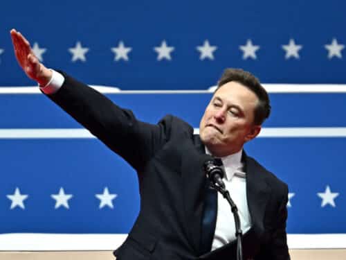 Tesla and SpaceX CEO Elon Musk gestures as he speaks during the inaugural parade inside Capitol One Arena, in Washington, DC, on January 20, 2025. (Photo by ANGELA WEISS / AFP) (Photo by ANGELA WEISS/AFP via Getty Images)