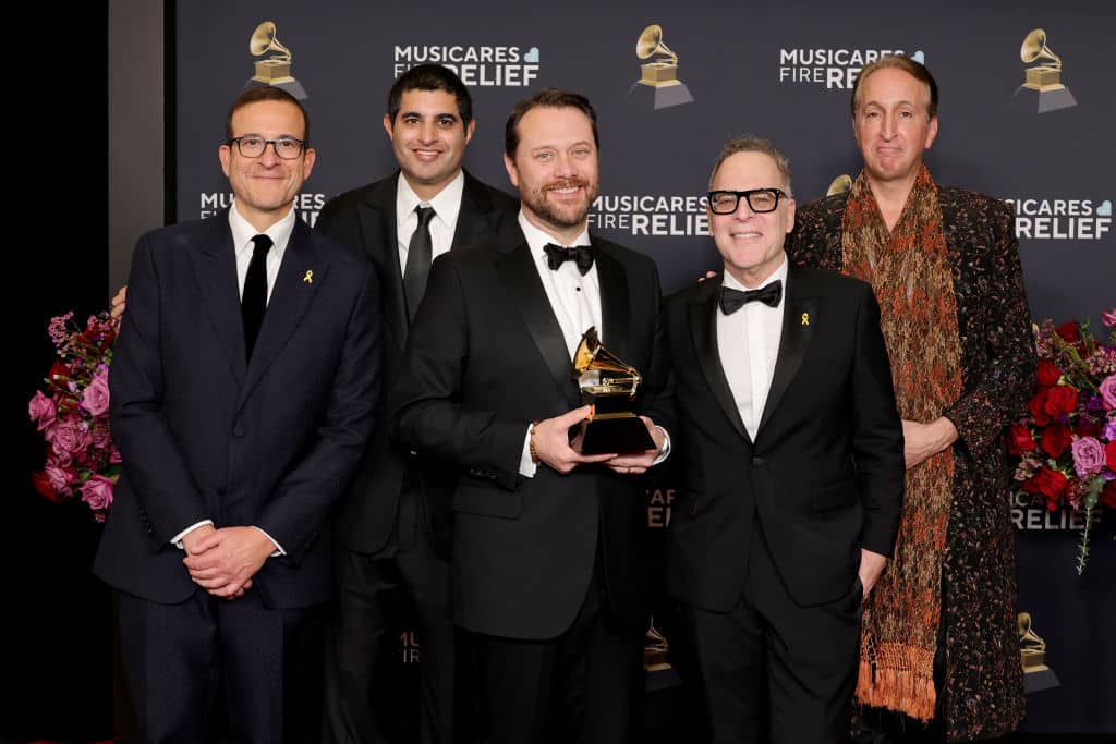 LOS ANGELES, CALIFORNIA - FEBRUARY 02: (L-R) Doug Davis, guest, Jason Carter, guest and Paul Avgerinos pose with an award in the press room during the 67th Annual GRAMMY Awards at Crypto.com Arena on February 02, 2025 in Los Angeles, California.  (Photo by Monica Schipper/Getty Images for The Recording Academy)