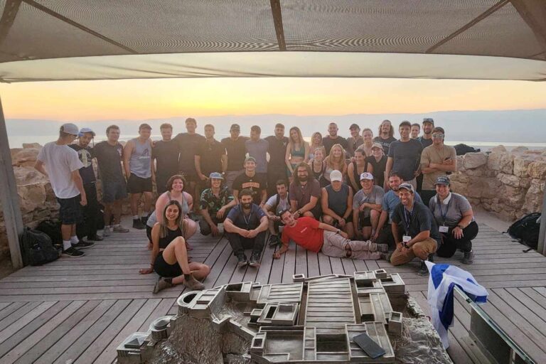 The Taglit-Birthright group smiling at sunrise (Courtesy of Aaron Herman)