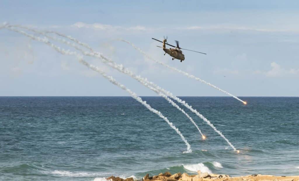 A Unit 669 helicopter flies away from enemy fire.