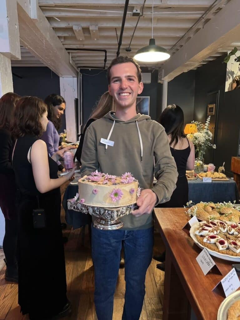 Nordheimer holding a cake he made for his cookbook club